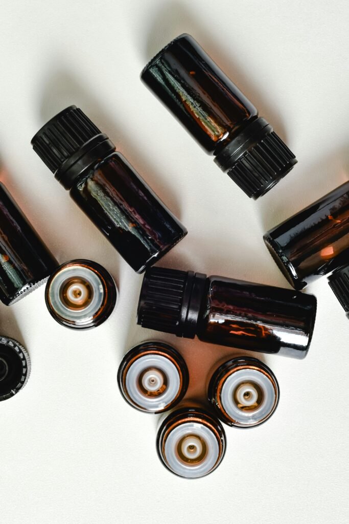 A top view of brown essential oil bottles on a white background, showcasing aromatherapy aesthetics.